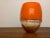 Charles (Charlie) Parriott glass vase that is smooth, orange blown glass on the top half and textured glass on the bottom...