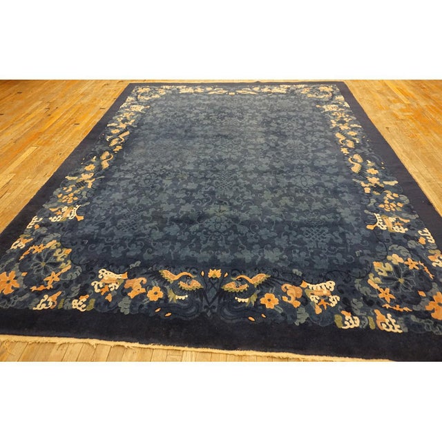 1920s Antique Wool Allover Floral Rectangle Blue Hand Knotted Pile Rug, Circa Date: 1920s. This exquisite example of early...