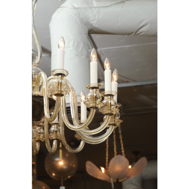 This is truly a grand example of a mid-century Venetian glass chandelier. It showcases sixteen brilliant sweeping glass...
