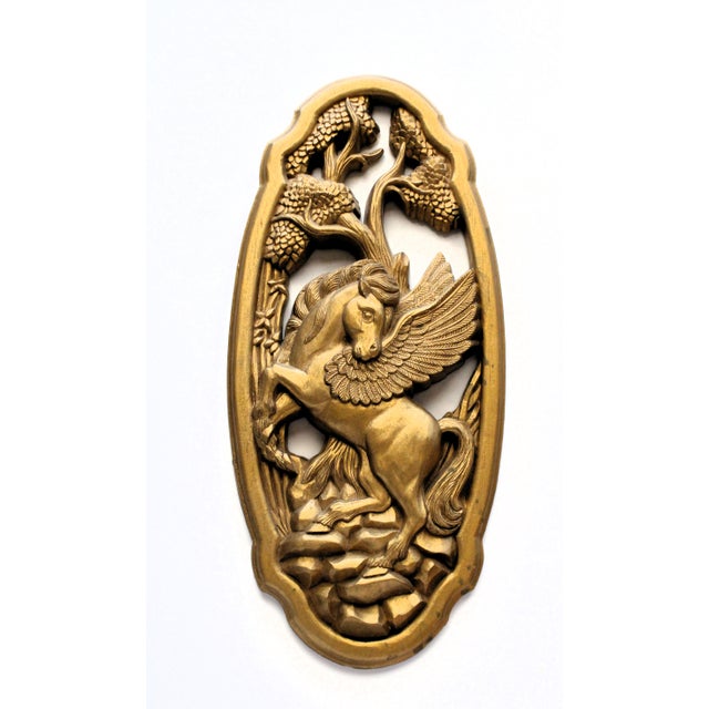 Pair of oval shaped wall mounted gilded ornate design featuring a Pegasus (winged horse) and a rearing unicorn. Antique...