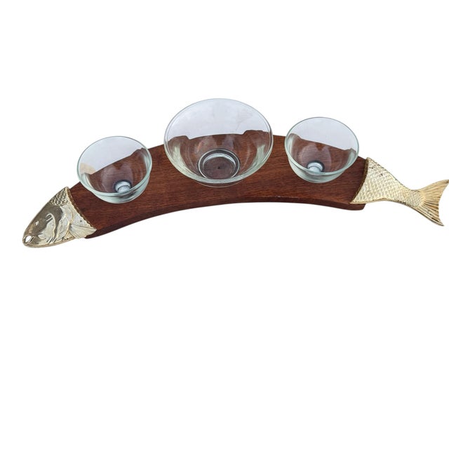 Mid century modern fish serving set made from brass plate and wood and glass. In good condition with minor losses to the...