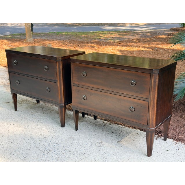Very nice pair of 2 drawer British Colonial style bachelors bedside chests. Deep dark island style mahogany finish. Simple...
