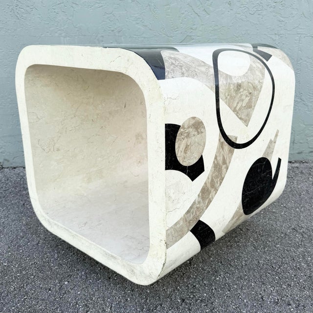 A bold Postmodern waterfall side table crafted in tessellated stone and adorned with an eye-catching abstract inlay...