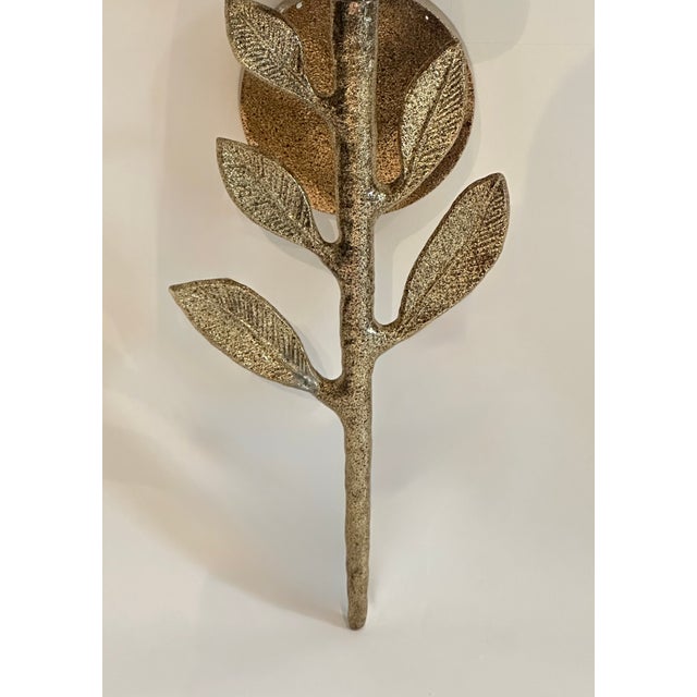 This Emmeline sconce from Made Goods has a delicate leaf and branch designed. The finish is a electroplated antique brass...