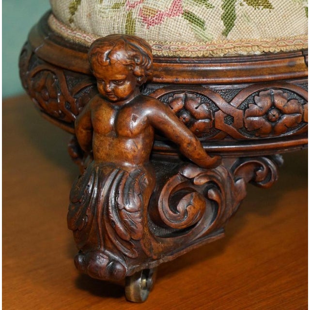 English Walnut ornately hand carved footstool with period castors and Embroidered top A very good looking well made and...