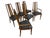 Elevate your dining space with this stylish set of six circa 1970s walnut dining chairs featuring elegant cane backs....