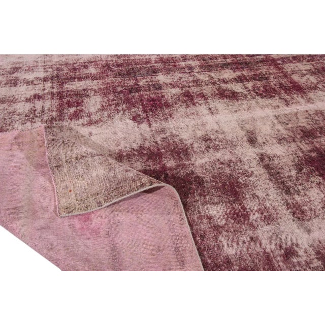 A hand-knotted vintage distressed Tabriz rug. This rug measures 9'9" x 12'3".