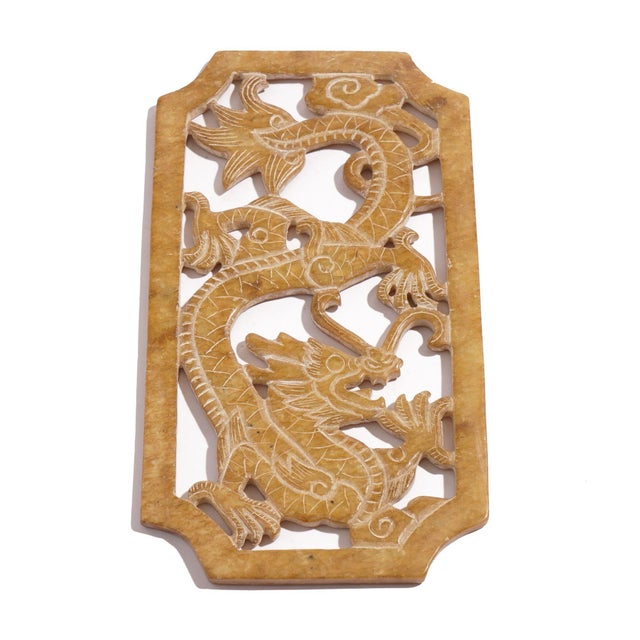 Rare Chinese pierced and carved jade plaque or pectoral amulet in the archaic style. The carving depicts a coiled dragon...