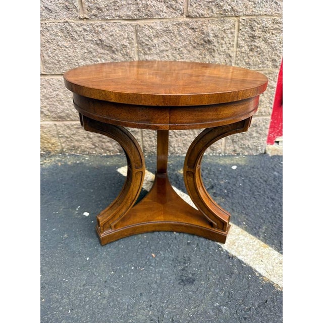 Vintage regency style burled wood round side table by Drexel It features round top with curvaceous legs and a central...