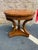 Vintage regency style burled wood round side table by Drexel It features round top with curvaceous legs and a central...
