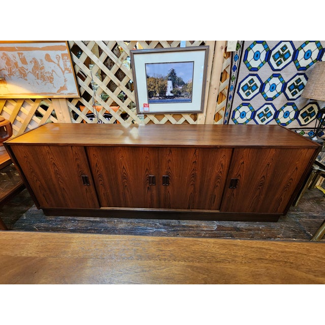 Stunning vintage 1960s Mid Century Modern rosewood credenza featuring gorgeous dramatic wood grain, clean architectural...