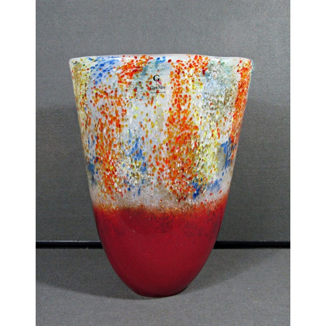 A large handmade Lithuanian art glass vase by Glass Nuvo, with a bold contemporary silhouette and vivid multicolor...