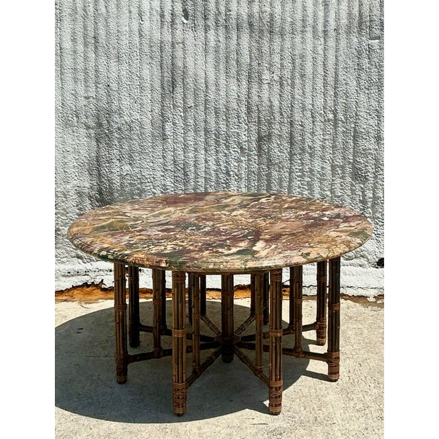 A breathtaking fusion of organic elegance and natural artistry, this vintage McGuire center hall table features their...