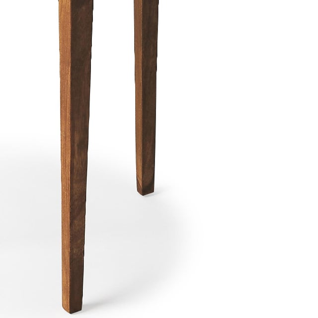 This petite accent table has a distinct Mid-century modern aesthetic. Crafted entirely from acacia Wood solids, it...
