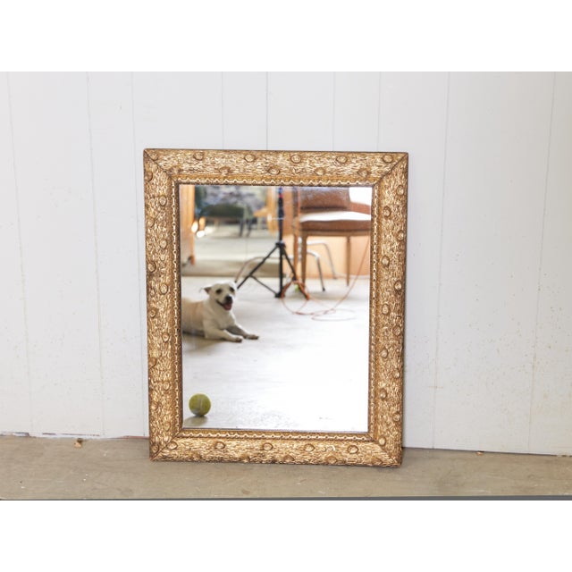 A French giltwood mirror from the early 20th century, with faux-bois carved frame and clear mirror plate. Created in...