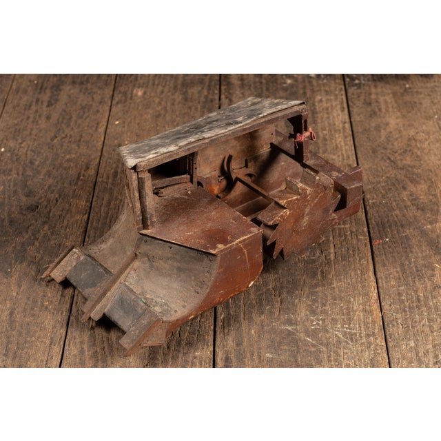 Hand-fabricated mechanical patent model constructed of wood with a tin-clad upper housing, illustrating a continuous...