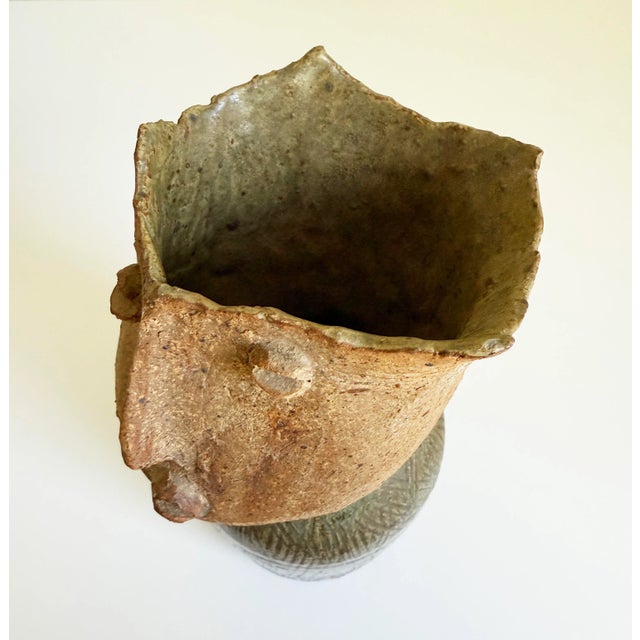 Mid-20th century artist signed folk art pottery vase featuring a stylized face in matte clay over an olive green glazed...