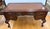 Handsome Sligh mahogany executive desk with a brown tooled leather writing surface, five drawers, and decorative brass...