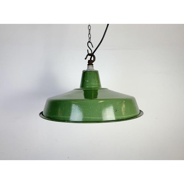 Industrial green enamel factory pendant light made in United Kingdom during the 1960s. White enamel inside the shade. Iron...