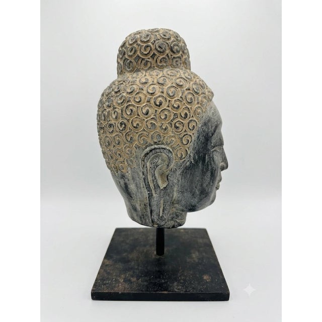 Overview Bring a sense of serene, monumental presence to your space with this striking Buddha head bust. Characterized by...
