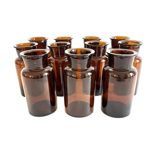 Set of 11 apothecary bottles from Belgian in a deep amber brown.