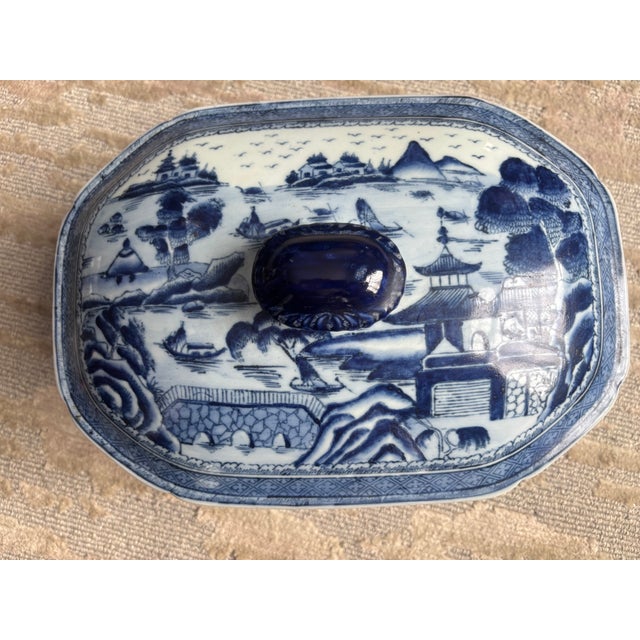 A large Canton glazed terra cotta tureen, circa 1820-40, decorated all over in deep cobalt blue landscape scenes with a...