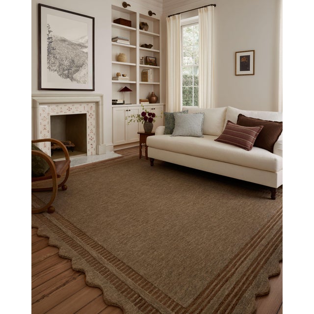 The Scottie Collection from Chris Loves Julia x Loloi is a hand-tufted wool area rug with a playful scalloped edge and...