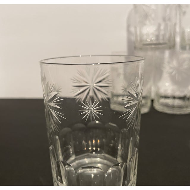 A set of seven 19th century cut glass tumblers, each decorated with star burst designs on the upper and arched panels on...