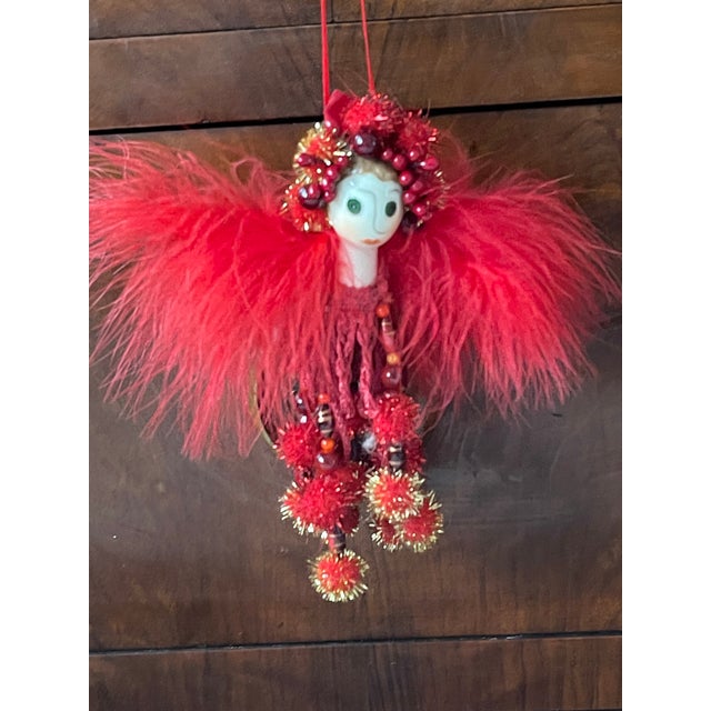 Red ostrich feathered angel figurine tassel. Collectible