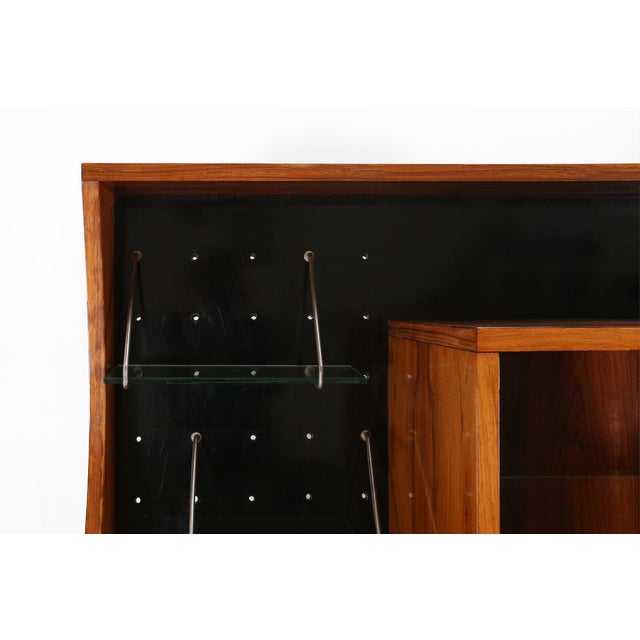 Very rare A-geometrically cabinet or highboard in wood with glass shelves. Designed in the 1960s in Italy. This special...