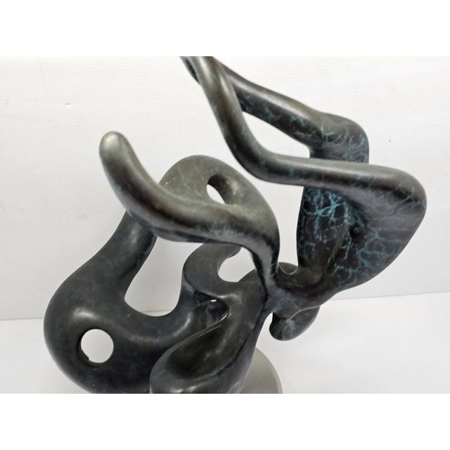 An impressive large-scale abstract bronze sculpture featuring fluid organic forms and a beautiful verdigris patina....
