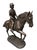 This elegant bronze sculpture captures a moment of poised athleticism, featuring a young rider—likely a boy in hunt or...