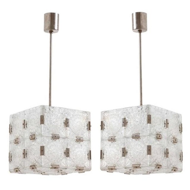 A pair cube shaped suspended cube light, circa 1960s made of clear molded glass panels and nickel metal joiners in the...