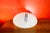 Table lamp with a chromed metal base and an opal glass shade. Interactive mechanism based on a chromed path that can be...