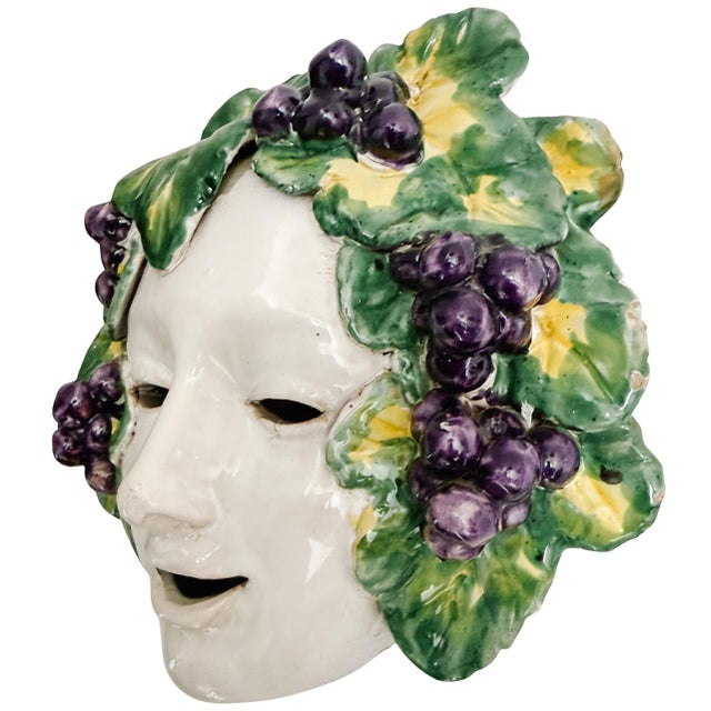 An exquisite vintage Italian glazed terracotta wall mask depicting Bacchus, beautifully hand-painted with vibrant purple...