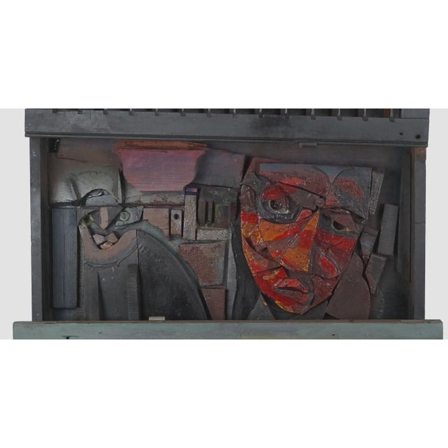 Whimsical wood assemblage/sculpture of a cat and man looking out a window with reclaimed shutters by Daniel Albert Harris...