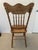 Beautiful antique solid oak press-back side chair featuring an elaborately embossed back with intricate floral scrollwork,...