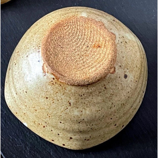 A set of four stoneware tea bowl by American ceramist Warren Mackenzie (1924-2018). The bowls were potted free-handed with...