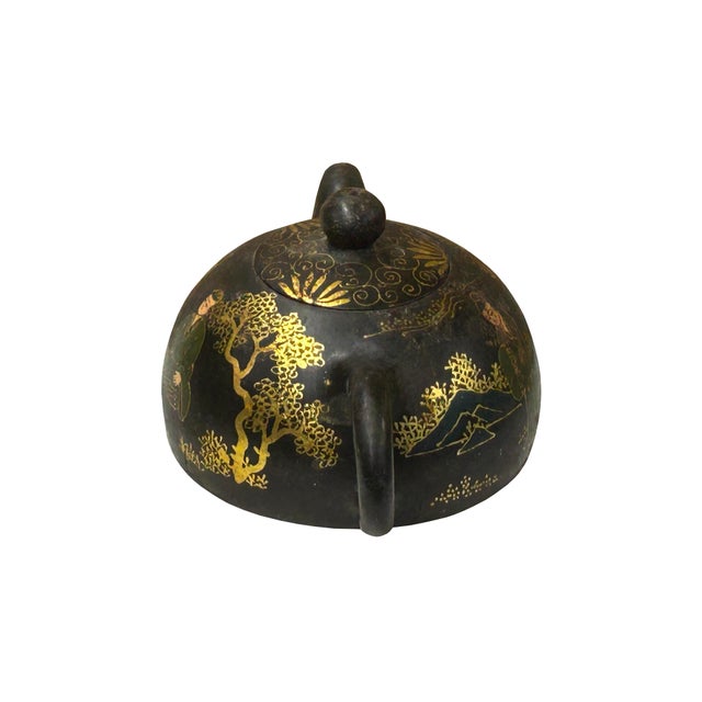 This appears to be a vintage or antique dark-clay teapot, likely of Chinese origin, characterized by its rounded, squat...