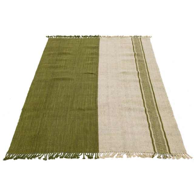 This minimalist Modern Kilim Style Wool Rug features a sophisticated, asymmetric color-block design that brings a...