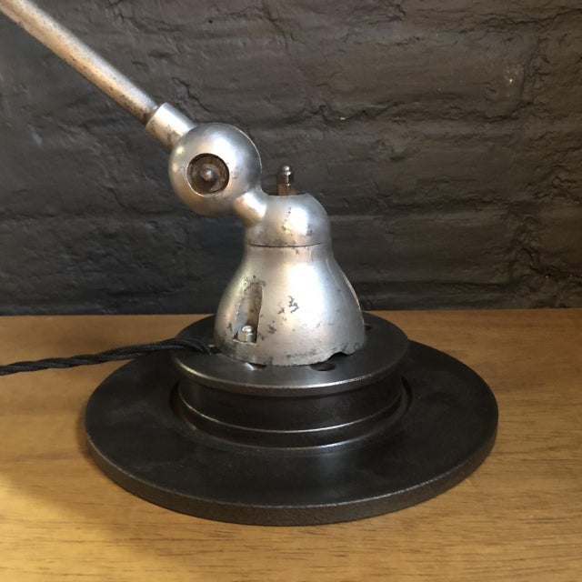 Beautiful original stripped and polished Jielde two arm wall light. Designed by the French engineer, Jean-Louis Domecq, in...