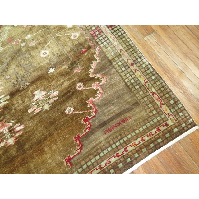 One of a kind mid-20th century Turkish Kars rug with a predominant brown ground with 2 gray brown medallions with some...