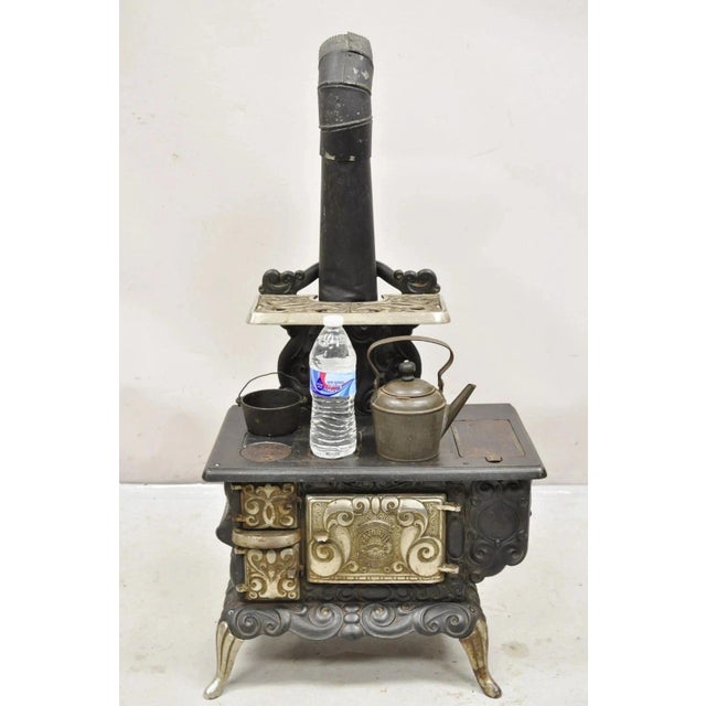 Antique Dolly's Favorite Cast Iron Childs Salesman Sample Stove by Favorite Stove. Circa Early 20th Century. Measurements:...