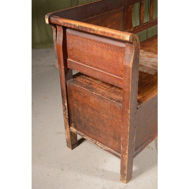 A charming folk art pine marriage bench, originating from Eastern Europe, in its original scumble painted decoration, with...