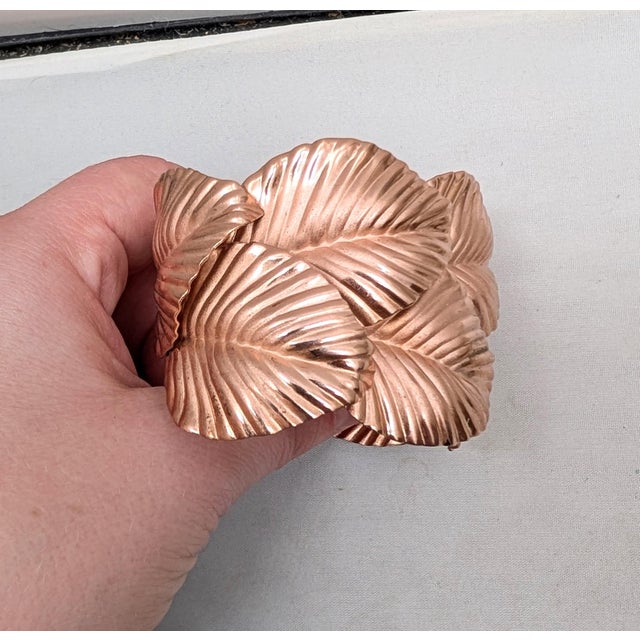 1982 rose goldtone textured double leaves wide slip on cuff braclet. Marked "NAPIER" on the inside edge of the bracelet...