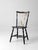 An antique brace-back Windsor chair dating from the late 19th to early 20th century, featuring a dark blue painted frame...