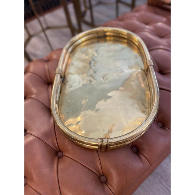 Large oval brass tray, produced in Milan, Italy, during the 1970s, as indicated by the logo stamped in the center. The...