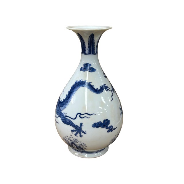 Elevate your interior decor with this vintage blue and white dragon porcelain art vase, showcasing print cobalt blue...