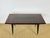 A sublime art deco extendable table crafted from varnished macassar ebony, featuring a magnificent vertical grain veneer...