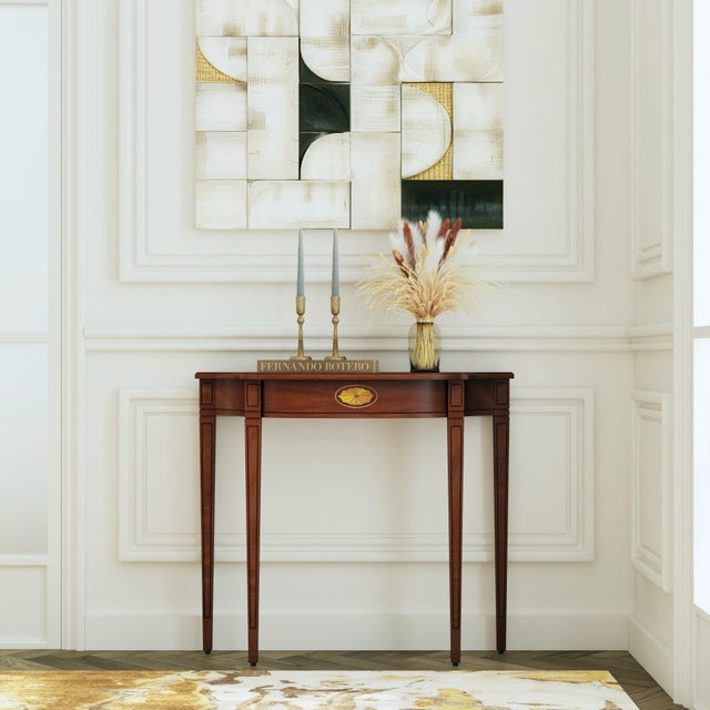 Inspired by the timeless elegance of Pembroke designs, this Butler Specialty Company demilune console table exudes...